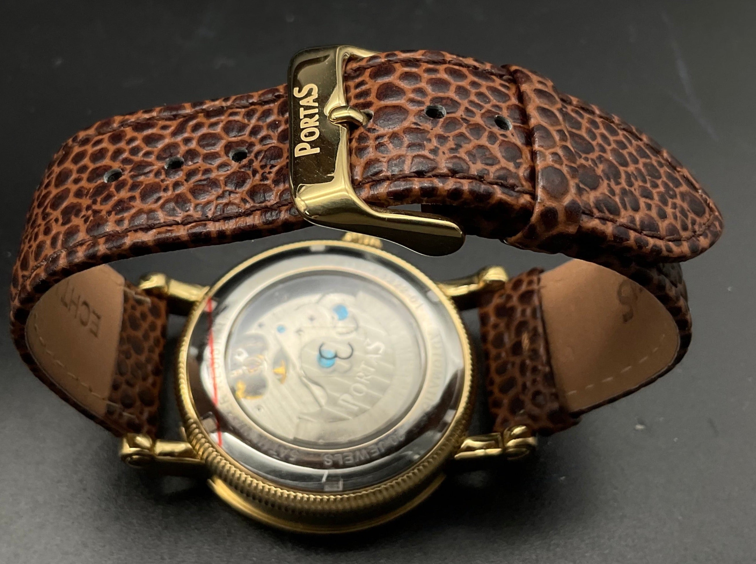 Gold-braune Portas Uhr